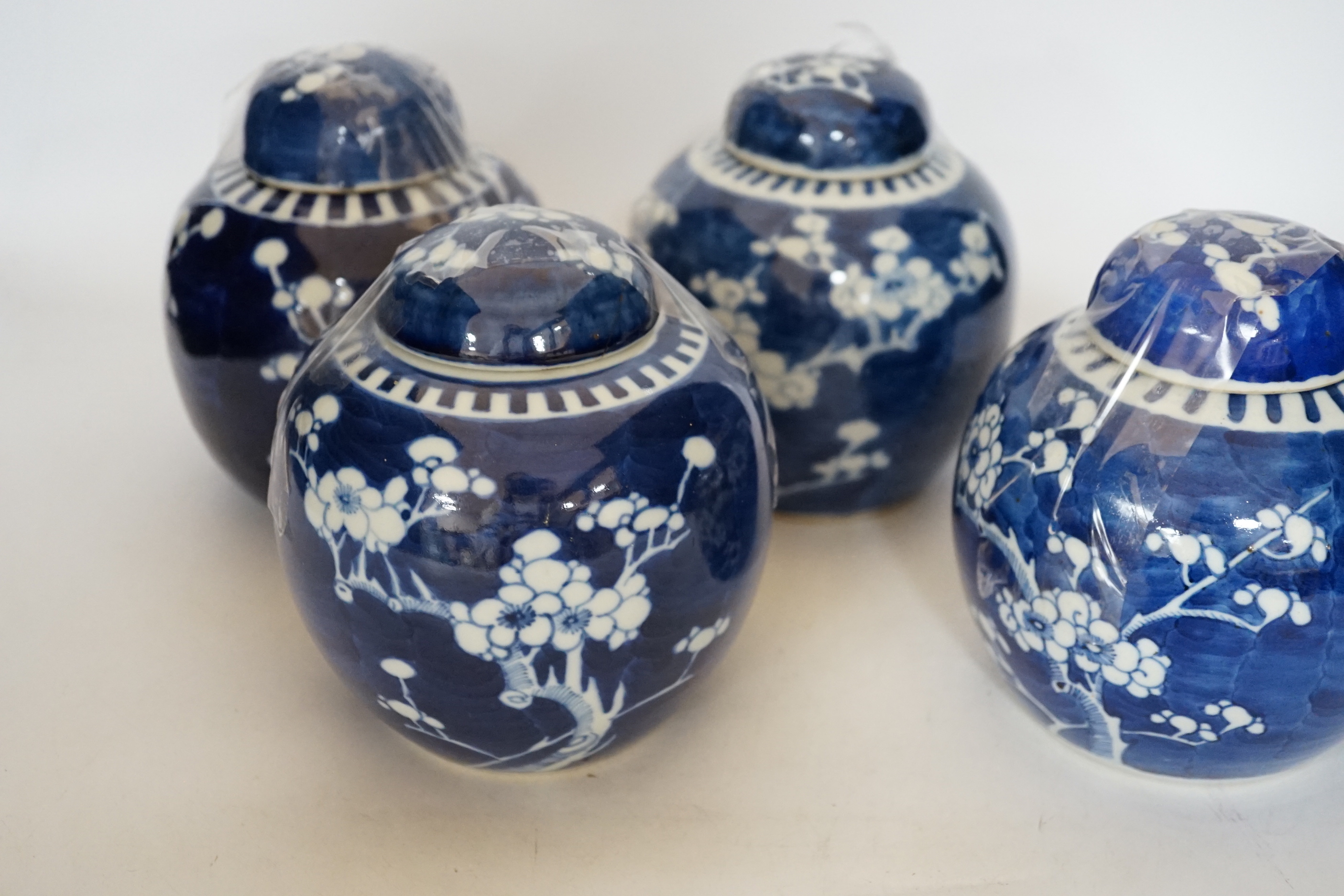 Five Chinese blue and white prunus jars and covers